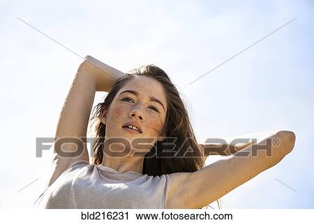 Caucasian woman standing under blue sky View Large Photo Image Stock Image - Caucasian woman standing under blue sky. Fotosearch