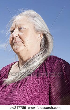 Caucasian woman standing under blue sky View Large Photo Image Stock Photography - Caucasian woman standing under blue sky. Fotosearch