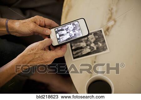 Caucasian woman taking cell phone picture of photograph View Large Photo Image Stock Image - Caucasian woman taking cell phone picture of photograph. Fotosearch