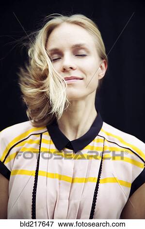 Stock Photo - Caucasian woman tossing her hair. Fotosearch