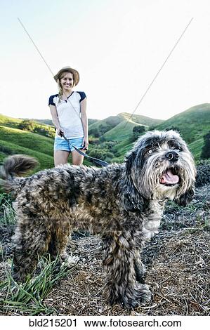 Caucasian woman walking dog on rural hilltop View Large Photo Image Stock Image - Caucasian woman walking dog on rural hilltop. Fotosearch