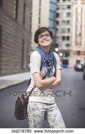 Stock Photography - Caucasian woman walking in city. Fotosearch