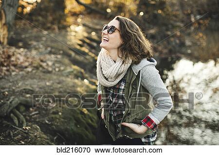 Stock Image - Caucasian woman walking in park. Fotosearch