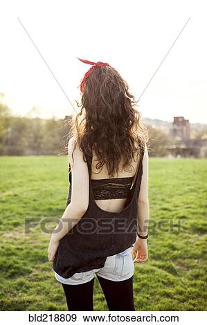 Stock Photo - Caucasian woman walking in urban park. Fotosearch