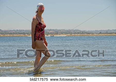 Caucasian woman walking in waves on beach View Large Photo Image Stock Photography - Caucasian woman walking in waves on beach. Fotosearch