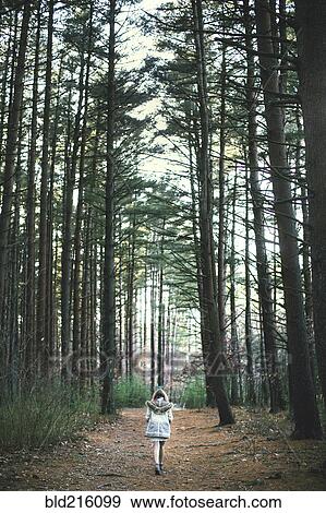 Caucasian woman walking on dirt path in forest View Large Photo Image Stock Photo - Caucasian woman walking on dirt path in forest. Fotosearch