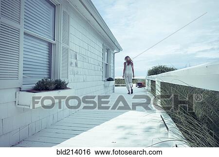 Caucasian woman walking on porch View Large Photo Image Stock Photograph - Caucasian woman walking on porch. Fotosearch