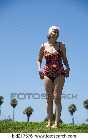 Caucasian woman wearing bathing suit in grass View Large Photo Image Stock Photograph - Caucasian woman wearing bathing suit in grass. Fotosearch