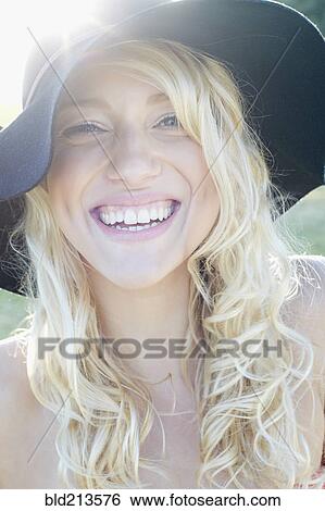Stock Photograph - Caucasian woman wearing floppy hat. Fotosearch