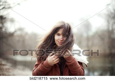 Stock Photography - Caucasian woman wearing furry coat outdoors. Fotosearch