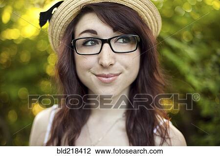 Stock Image - Caucasian woman wearing hat outdoors. Fotosearch