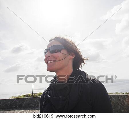 Caucasian woman wearing sunglasses and windbreaker View Large Photo Image Stock Photo - Caucasian woman wearing sunglasses and windbreaker. Fotosearch