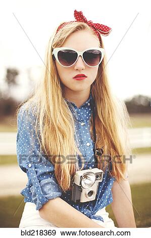 Caucasian woman wearing sunglasses and instant camera View Large Photo Image Stock Photo - Caucasian woman wearing sunglasses and instant camera. Fotosearch