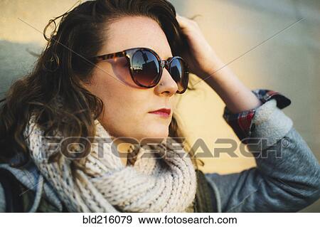 Stock Photo - Caucasian woman wearing sunglasses outdoors. Fotosearch