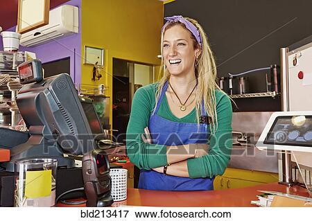 Stock Photo - Caucasian woman working in cafe. Fotosearch