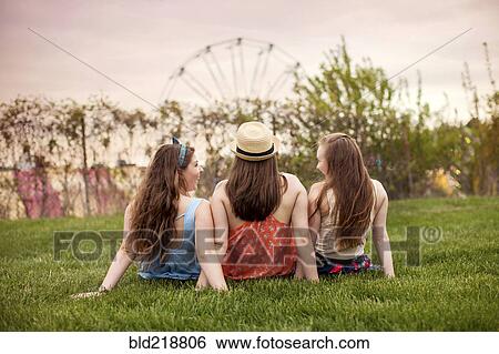 Caucasian women sitting in urban park View Large Photo Image Stock Photograph - Caucasian women sitting in urban park. Fotosearch