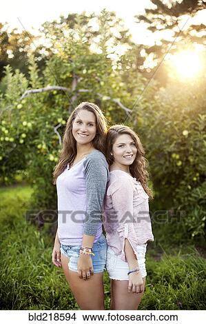 Picture - Caucasian women smiling in rural field. Fotosearch