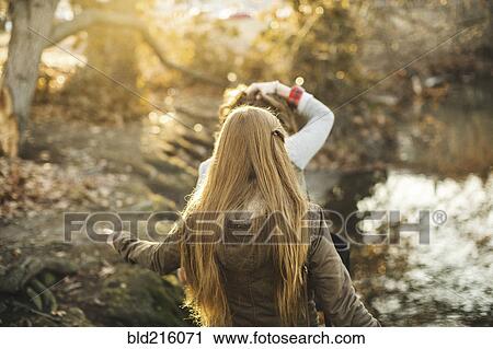 Caucasian women walking in park View Large Photo Image Stock Image - Caucasian women walking in park. Fotosearch
