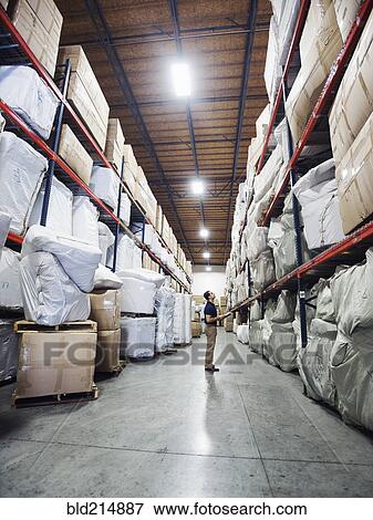 Caucasian worker checking inventory in warehouse View Large Photo Image Stock Photo - Caucasian worker checking inventory in warehouse. Fotosearch