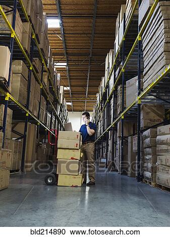 Caucasian worker using laptop in warehouse View Large Photo Image Stock Image - Caucasian worker using laptop in warehouse. Fotosearch