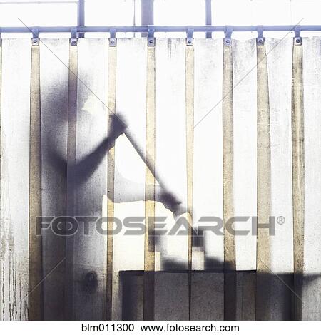 Caucasian worker working behind plastic curtain View Large Photo Image Stock Image - Caucasian worker working behind plastic curtain. Fotosearch