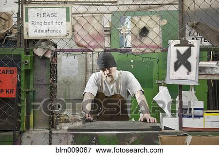 Stock Photo - Caucasian worker working in factory. Fotosearch