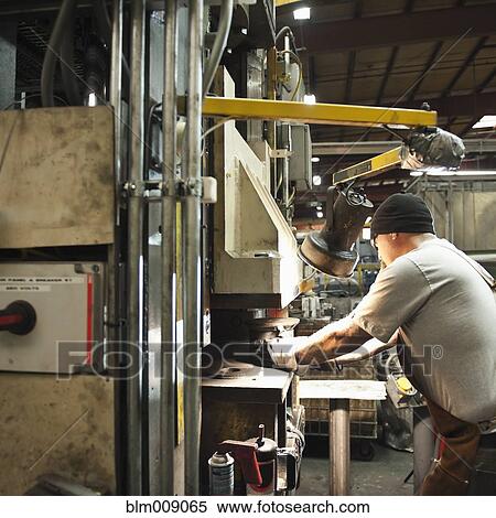 Stock Photography - Caucasian worker working in factory. Fotosearch