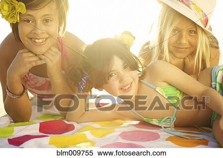 Children in bikinis laying on towel View Large Photo Image Stock Photography - Children in bikinis laying on towel. Fotosearch