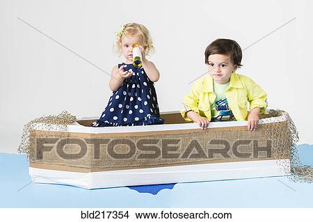 Picture - Children playing in cardboard boat. Fotosearch