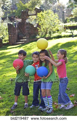 Children playing with balls in grass View Large Photo Image Stock Photo - Children playing with balls in grass. Fotosearch