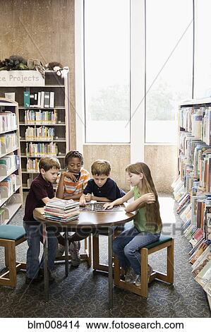 Children reading book together in library View Large Photo Image Picture - Children reading book together in library. Fotosearch
