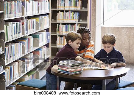 Children reading book together in library View Large Photo Image Stock Photo - Children reading book together in library. Fotosearch