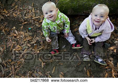 Stock Photo - Children smiling on forest ground. Fotosearch