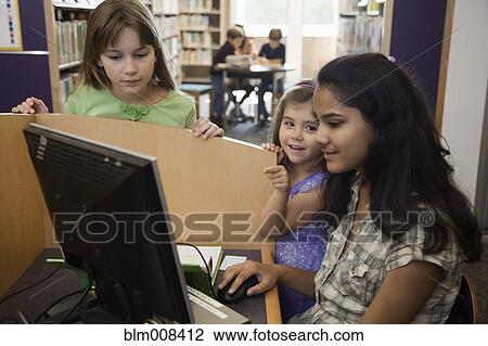 Children using computer in library together View Large Photo Image Stock Image - Children using computer in library together. Fotosearch