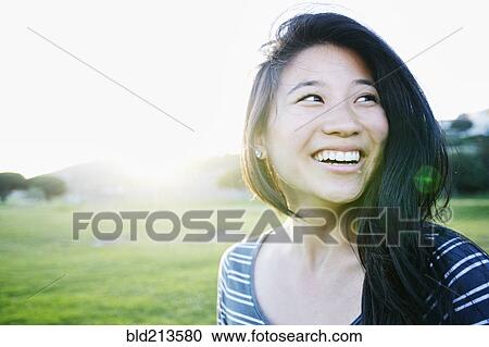 Chinese woman smiling outdoors View Large Photo Image Stock Image - Chinese woman smiling outdoors. Fotosearch