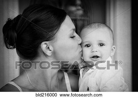 Close up mixed race mother kissing baby son View Large Photo Image Stock Image - Close up mixed race mother kissing baby son. Fotosearch