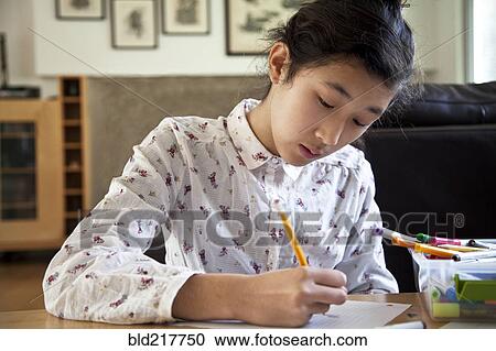 Close up of Asian teenage girl doing homework View Large Photo Image Stock Image - Close up of Asian teenage girl doing homework. Fotosearch