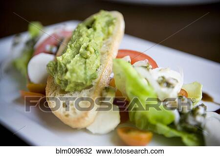 Stock Image - Close up of avocado salad on plate. Fotosearch