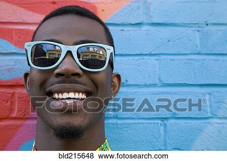 Close up of Black man wearing colorful sunglasses View Large Photo Image Stock Photo - Close up of Black man wearing colorful sunglasses. Fotosearch
