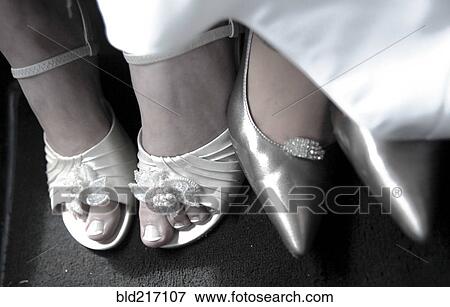 Stock Photo - Close up of bride and bridesmaid wearing high heels. Fotosearch