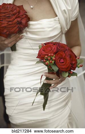 Picture - Close up of bride holding bouquets. Fotosearch