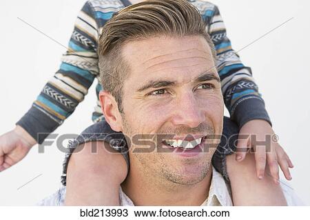Close up of Caucasian father holding son on shoulders View Large Photo Image Stock Image - Close up of Caucasian father holding son on shoulders. Fotosearch