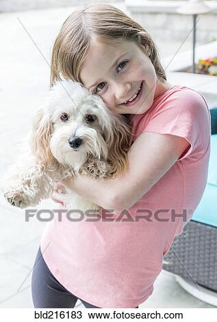 Close up of Caucasian girl hugging puppy View Large Photo Image Stock Image - Close up of Caucasian girl hugging puppy. Fotosearch