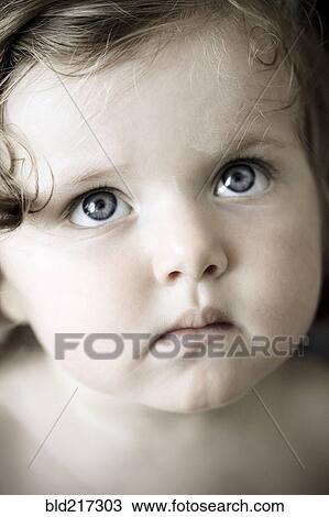 Stock Image - Close up of Caucasian girl looking up. Fotosearch