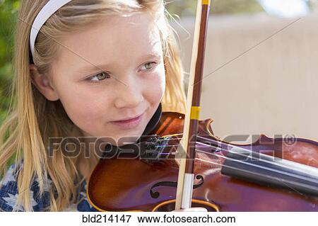 Close up of Caucasian girl playing violin View Large Photo Image Stock Photo - Close up of Caucasian girl playing violin. Fotosearch