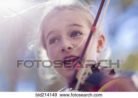 Close up of Caucasian girl playing violin View Large Photo Image Stock Photo - Close up of Caucasian girl playing violin. Fotosearch