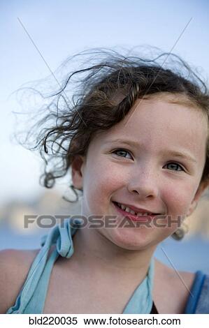 Stock Photography - Close up of Caucasian girl smiling outdoors. Fotosearch