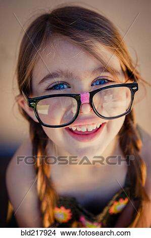 Picture - Close up of Caucasian girl wearing eyeglasses. Fotosearch