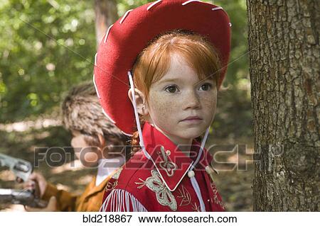 Stock Photo - Close up of Caucasian girl wearing cowgirl costume. Fotosearch