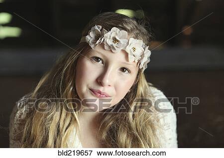 Stock Photo - Close up of Caucasian girl wearing flower crown. Fotosearch